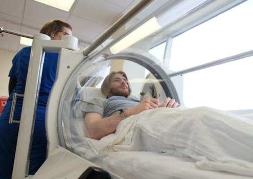 Man in a hyperbaric oxygen chamber