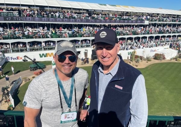 Jonathan Rotella, CEO of NexGen Hyperbaric, and Jerry Rosburg, football coach, pose for a photo.